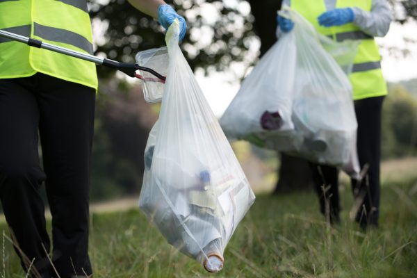 people-doing-community-service-by-collecting-trash-outdoors